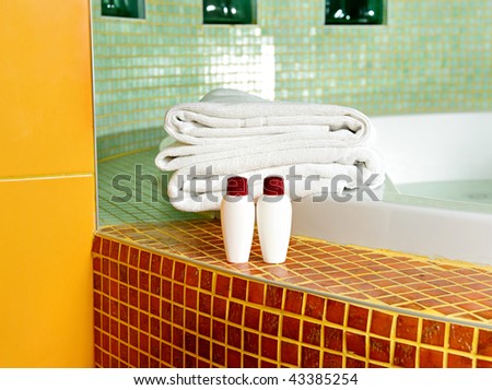 Towel, shampoo and gel in a bathroom