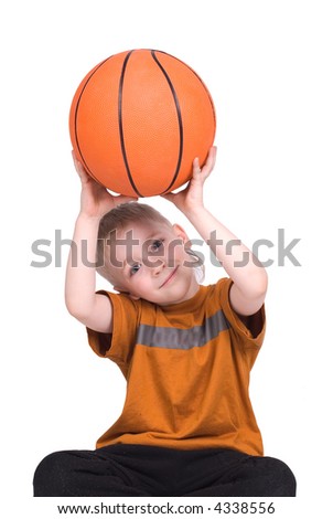 The boy sits with a basketball ball on white background