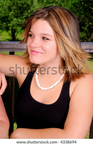 Teen Girl Enjoying The Summer Weather Outdoors On A Patio