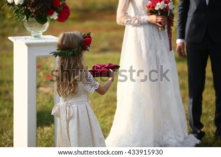 little girl Carrying Wedding Ring On Cushion Royalty-Free Stock Photo #433915930