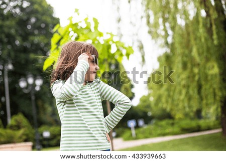Happy child playing in city park. Summer sunny picture