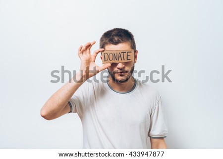 male, cardboard sign donation. On a gray background