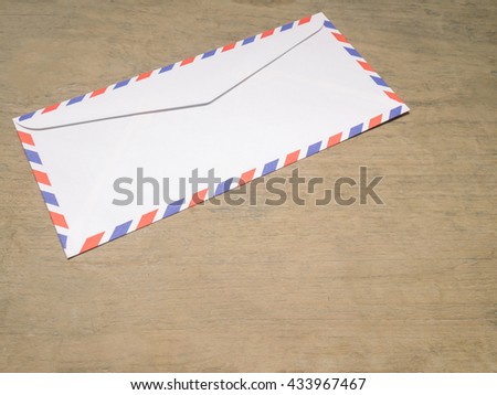 Air mail letter on wood background.