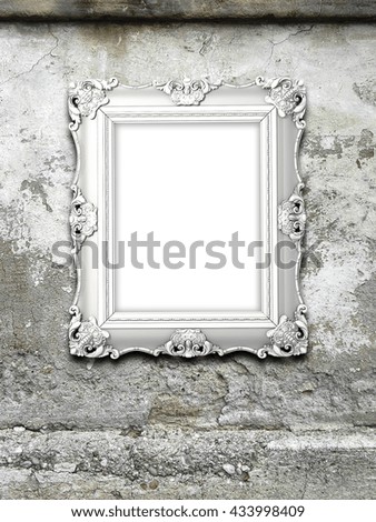 Close-up of one silver Baroque picture frame on gray weathered concrete wall background