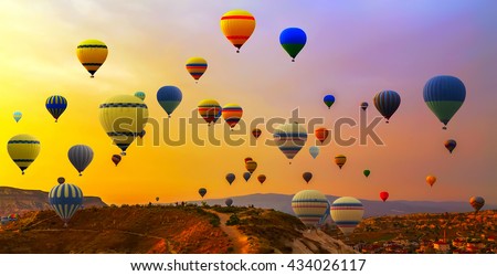 Hot air balloons landing in a mountain Cappadocia Goreme National Park Turkey. Royalty-Free Stock Photo #434026117