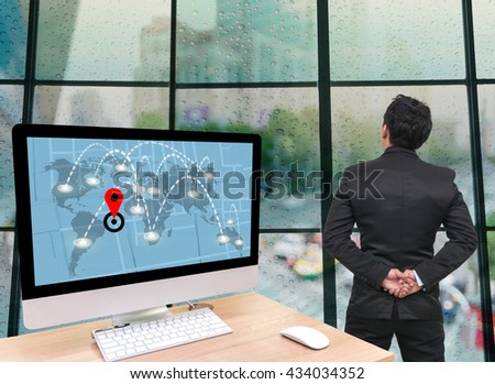 Back side of Businessman looking at traffic jam with Rain drop On the window Glass with technology Computer set showing part of navigator map, Elements of this image furnished by NASA