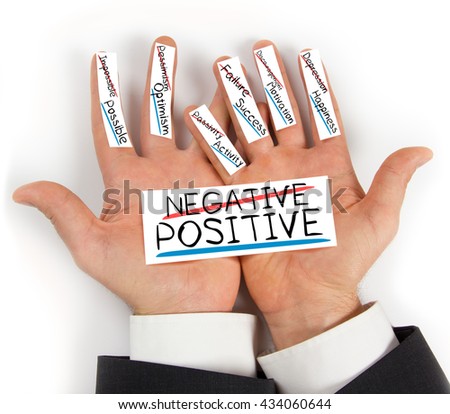 Photo of hands holding paper cards with NEGATIVE POSITIVE concept words