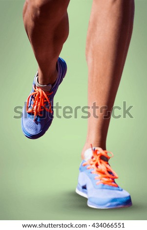 Close up of sportsman legs walking on a white background against green background