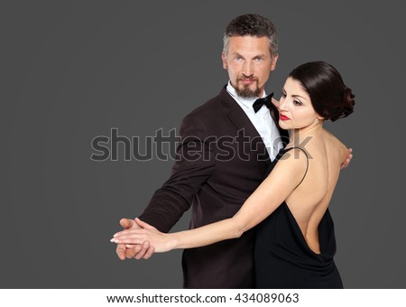 Happy mature couple on dark background