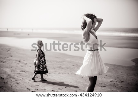 mother and young daughter portrait of summer on the sea