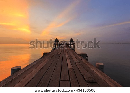 Seascape of Wooded bridge in the port during sunset time