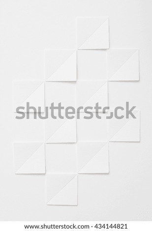 White paper squares over white background