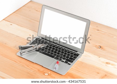 wrench on laptop concept fixing it
