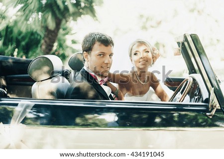 Young lovers ride retro car