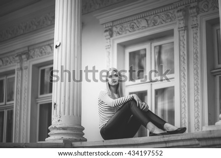 beautiful girl near the house with columns