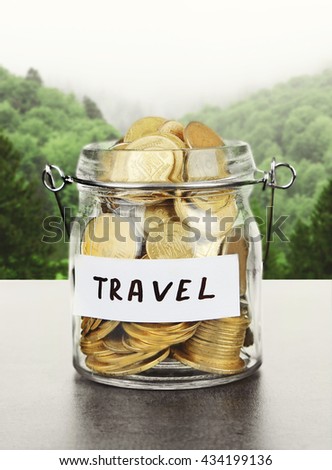 Jar for savings full of coins on forest background