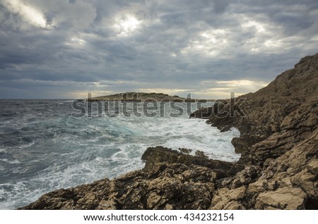 Sunset in village Razanj Croatia Europe. Landscape and nature. Adriatic Sea and a bay at dusk. Calm summer evening with beautiful colors. Cloud, sky, rock, stone and reef. Fine art picture.
