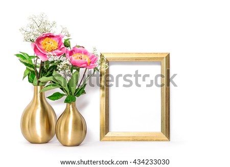 Golden picture frame and pink flowers. Minimal style decoration with space for your image text work