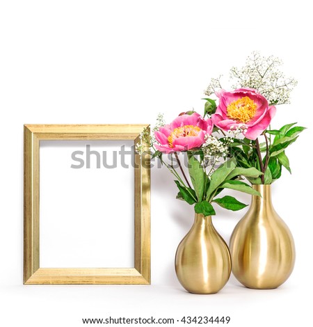 Picture frame and pink peony flowers. Minimal style golden decoration with space for your image