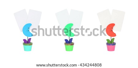 Closeup clamp photo in blue moon , green moon , orange moon shape in flowerpot with white blank paper isolated on white background