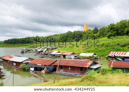 The houseboats foreground with natural background and golden pagoda.