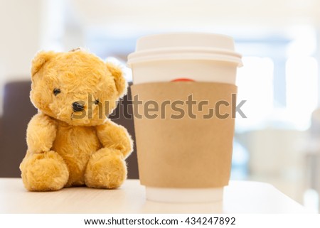 Coffee cup, blurred on teddy bear face in Blurred background with vintage filter