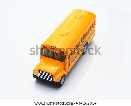 Yellow school bus plastic and metal toy isolated on a white background, represent every children were safe to go to school when they arrived to this bus on time.
