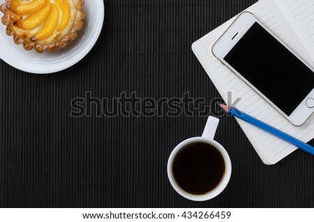 cup of coffee, smartphone diary and cake with copy space. Top view