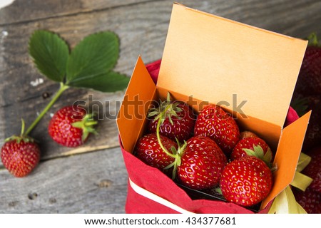 fresh strawberries in gift box with space for text (message, invitation, offer). Food Frame Background. creative thinking and original ads. soft selective focus Photo
