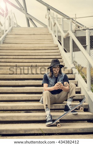 Cool guy in the city writing a message on his smart phone