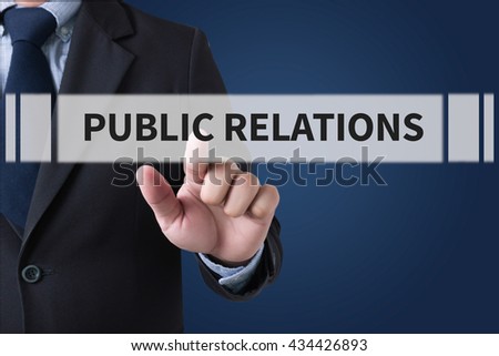 PUBLIC RELATIONS Businessman hands touching on virtual screen and blurred city background