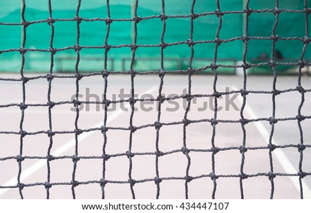 the black tennis net on blur the empty red tennis court. background