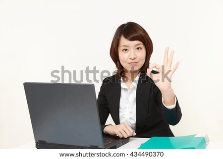 young Japanese business woman showing perfect sign