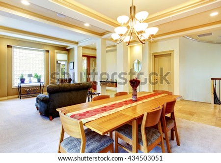 Cozy bright dining room connected with nicely furnished living room. View of entrance door.