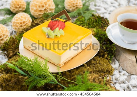 Mango mousse cake with homemade decoration and tea