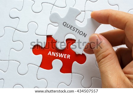 Hand holding piece of jigsaw puzzle with word QUESTION ANSWER. Royalty-Free Stock Photo #434507557