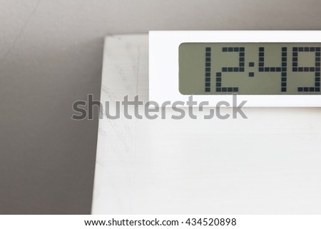 White clock digital modern on white table in bedroom.