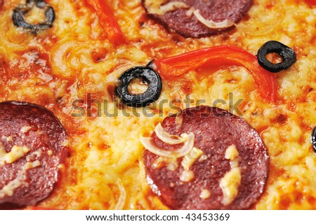 Close up of  pizza with tomatoes, cheese, black olives and  peppers