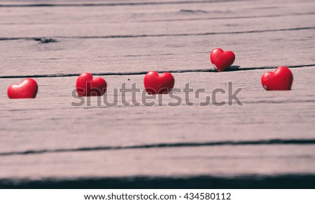 Valentine day background. Red heart on grunge wood table. Retro filter.