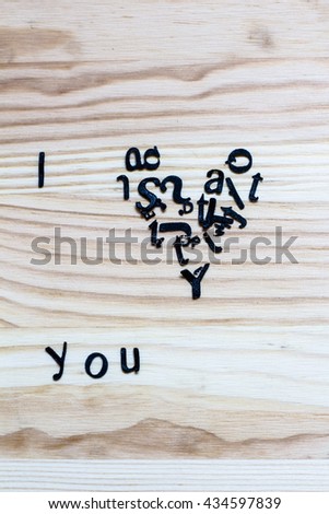Backgrounds, characters. Lined with letters on a wooden board. I love you.
