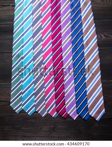 assorted colorful neckties on black table at shop