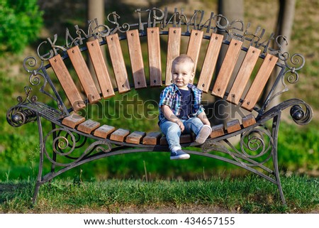 the boy sits on the bench