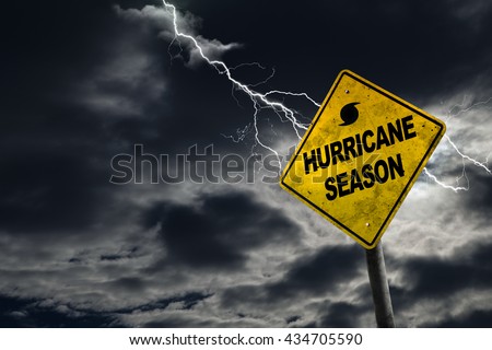 Hurricane season with symbol sign against a stormy background and copy space. Dirty and angled sign adds to the drama. Royalty-Free Stock Photo #434705590