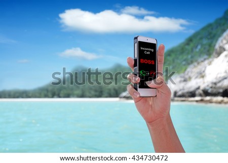 "Incoming call BOSS" showing on the smartphone with tropical island background.