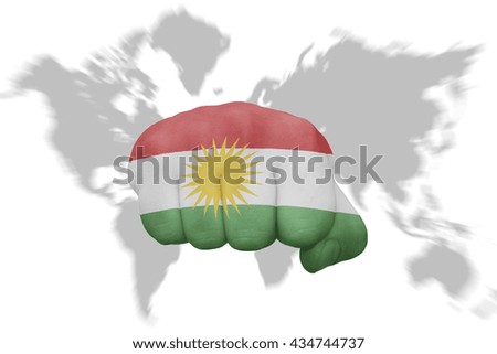 fist with the national flag of kurdistan on a world map background