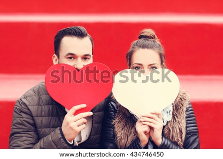 Picture of romantic couple having fun with hearts