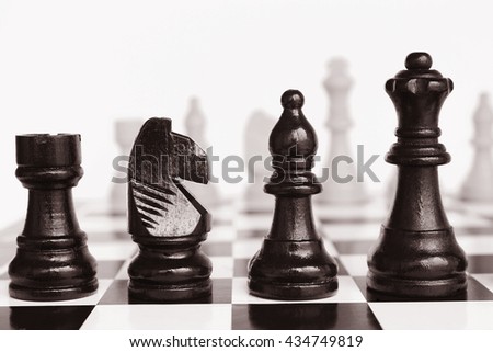 Wooden Chess pieces on a chessboard. Tinted photos.
