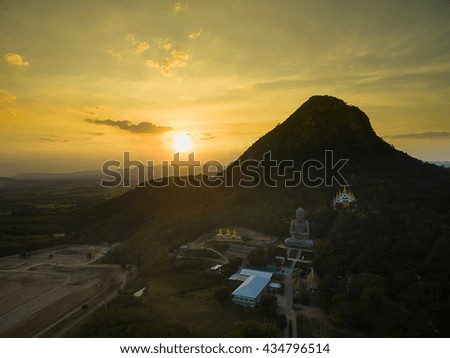Sunset and Buddhist Temple behind mountain , Thailand , warm tone , low key exposure , aerial photography