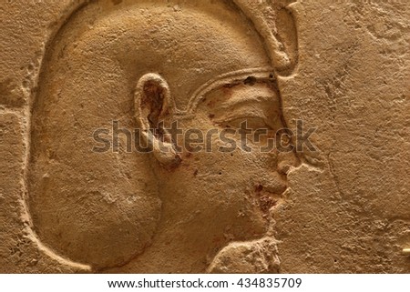 Ancient Egyptian relief carving showing the face of Pharaoh.