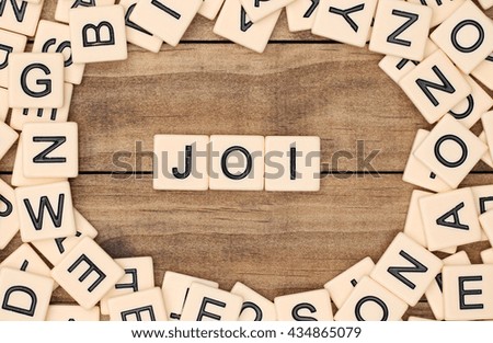 Joi - Joy in French spelled out in tan tile letters